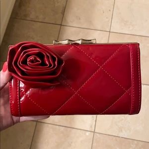 Elaine Turner red patent clutch with rose